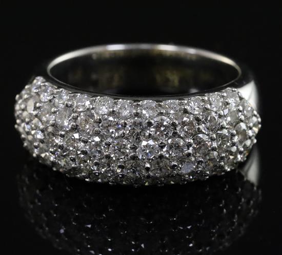 A modern 18ct white gold and pave set diamond half hoop dress ring, size K.